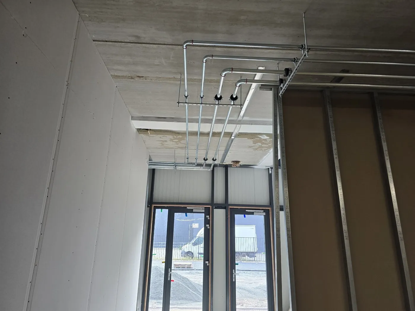 Pipework on the ceiling by the clinic's glass frontage