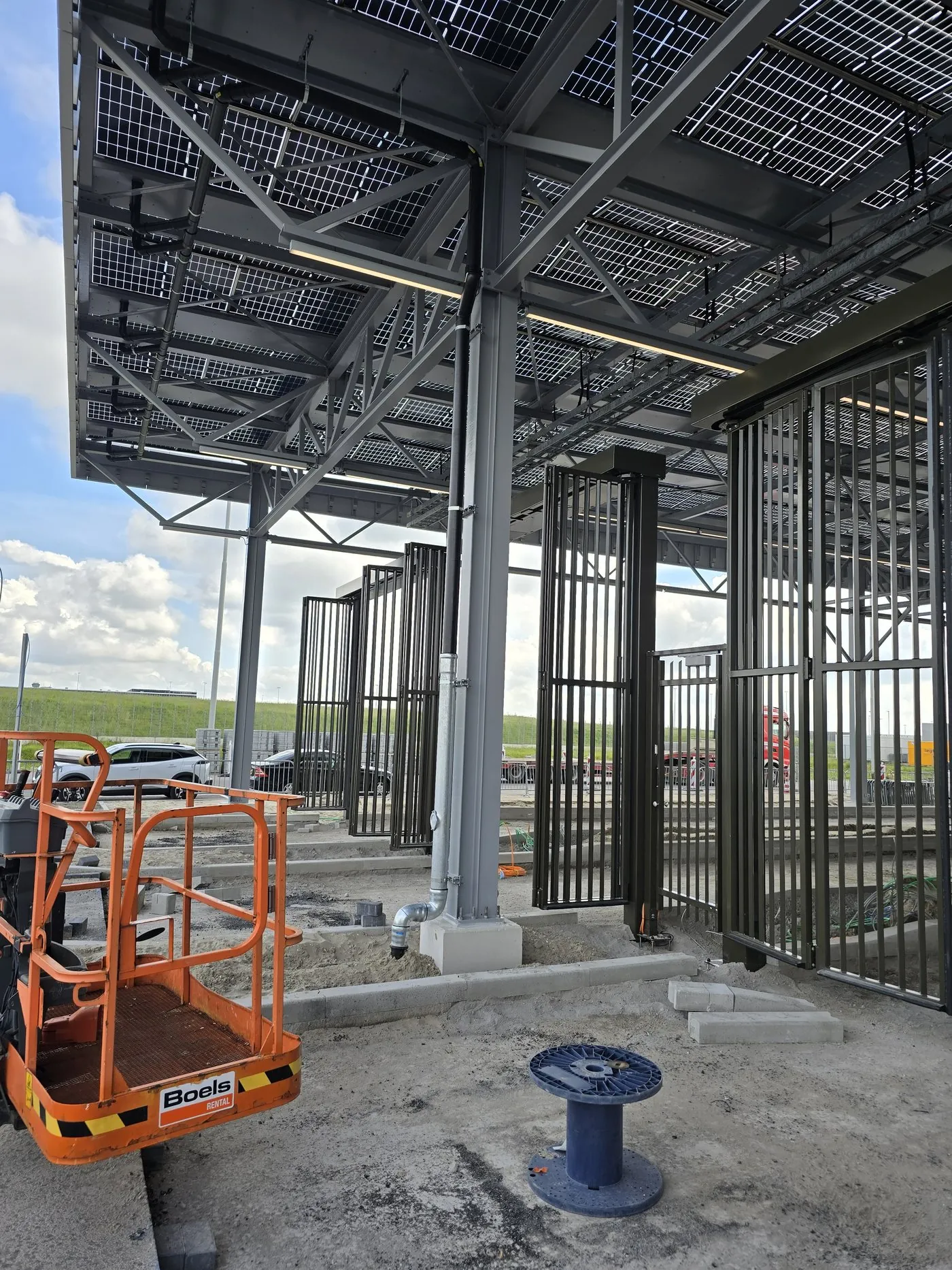 Aerial work platform under the solar roof during installation of the pipework