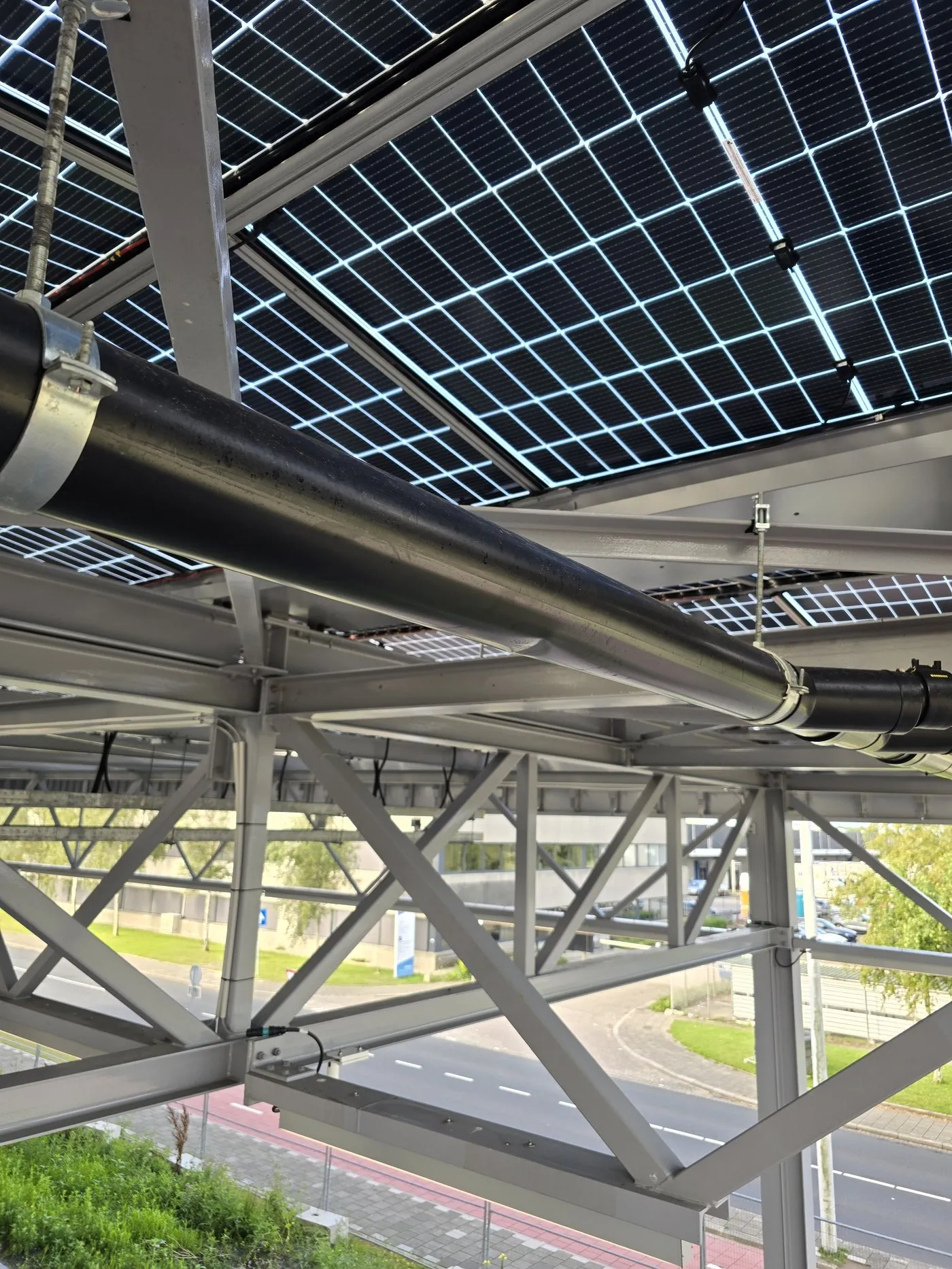 Installed pipe fixed to the steel structure beneath the solar panels